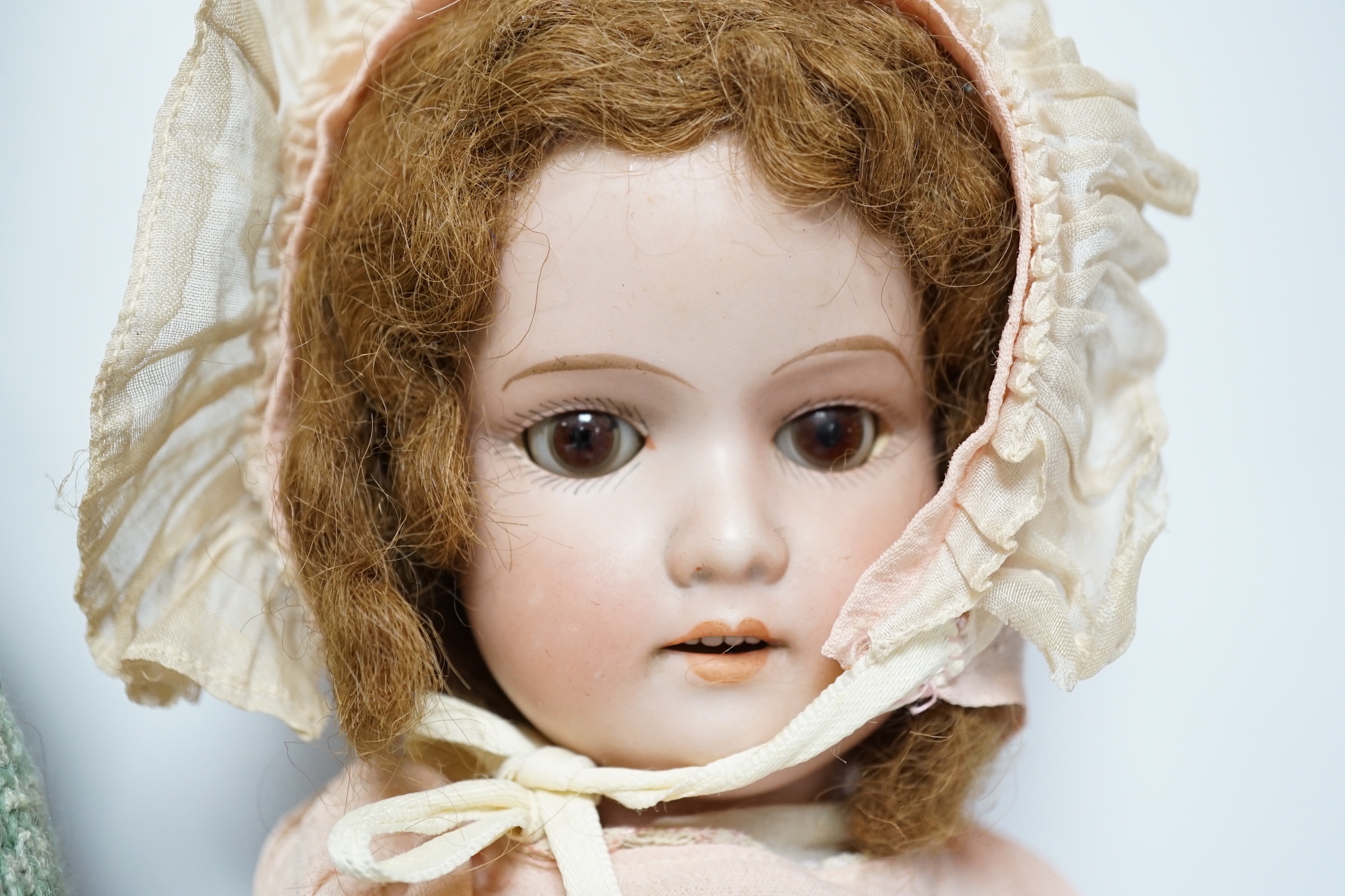 An AM390 bisque head doll, 63cm good condition, and an AM390, missing two fingers and wear on other hand, 58cm